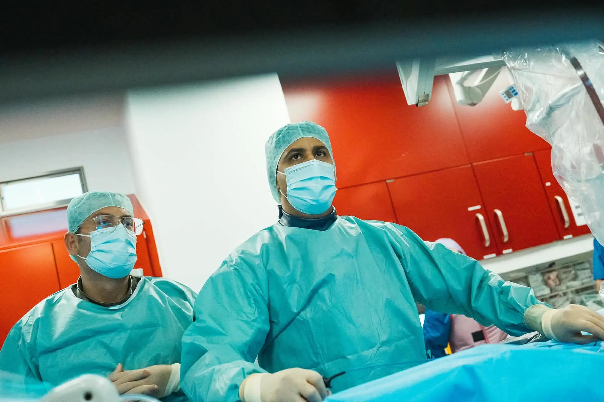 Two electrophysiologists following a catheter ablation on the lab monitors